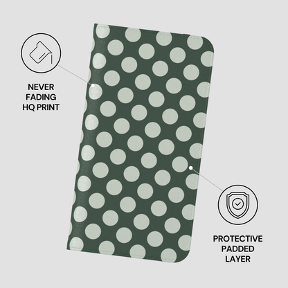 Green fabric with white polka dots on a light gray background