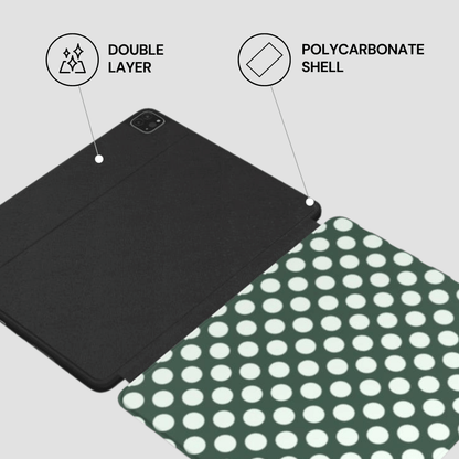 Black tablet case with polycarbonate shell and double layer feature on a green and white polka dot background.