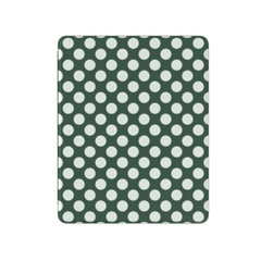 Green fabric with white polka dots on a white background