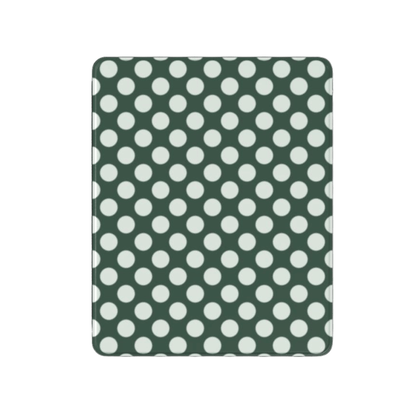 Green fabric with white polka dots on a white background
