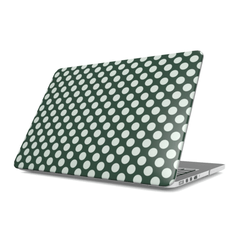 Laptop with a green and white polka dot case on a white background