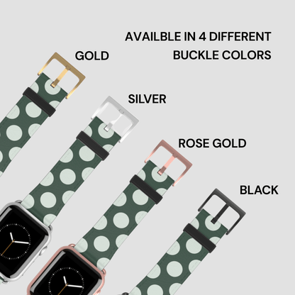 Green polka dot watch band with gold, silver, rose gold, and black buckles on a light gray background.