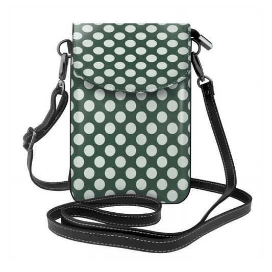 Green crossbody bag with white polka dots on a white background