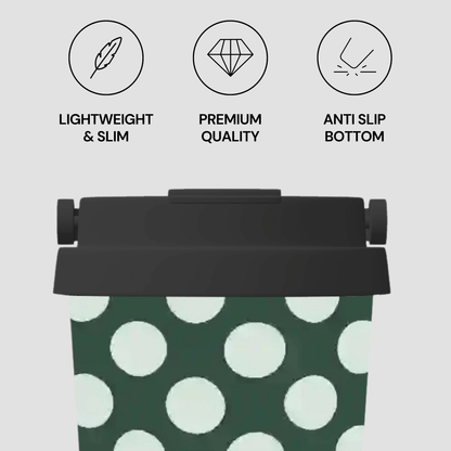 Green and white polka dot bag with black lid and text indicating features on a light gray background