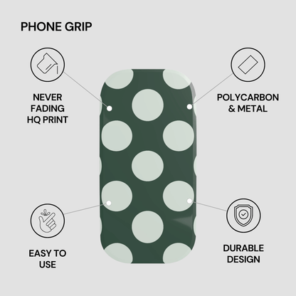 Phone grip with green and white polka dot pattern on a gray background