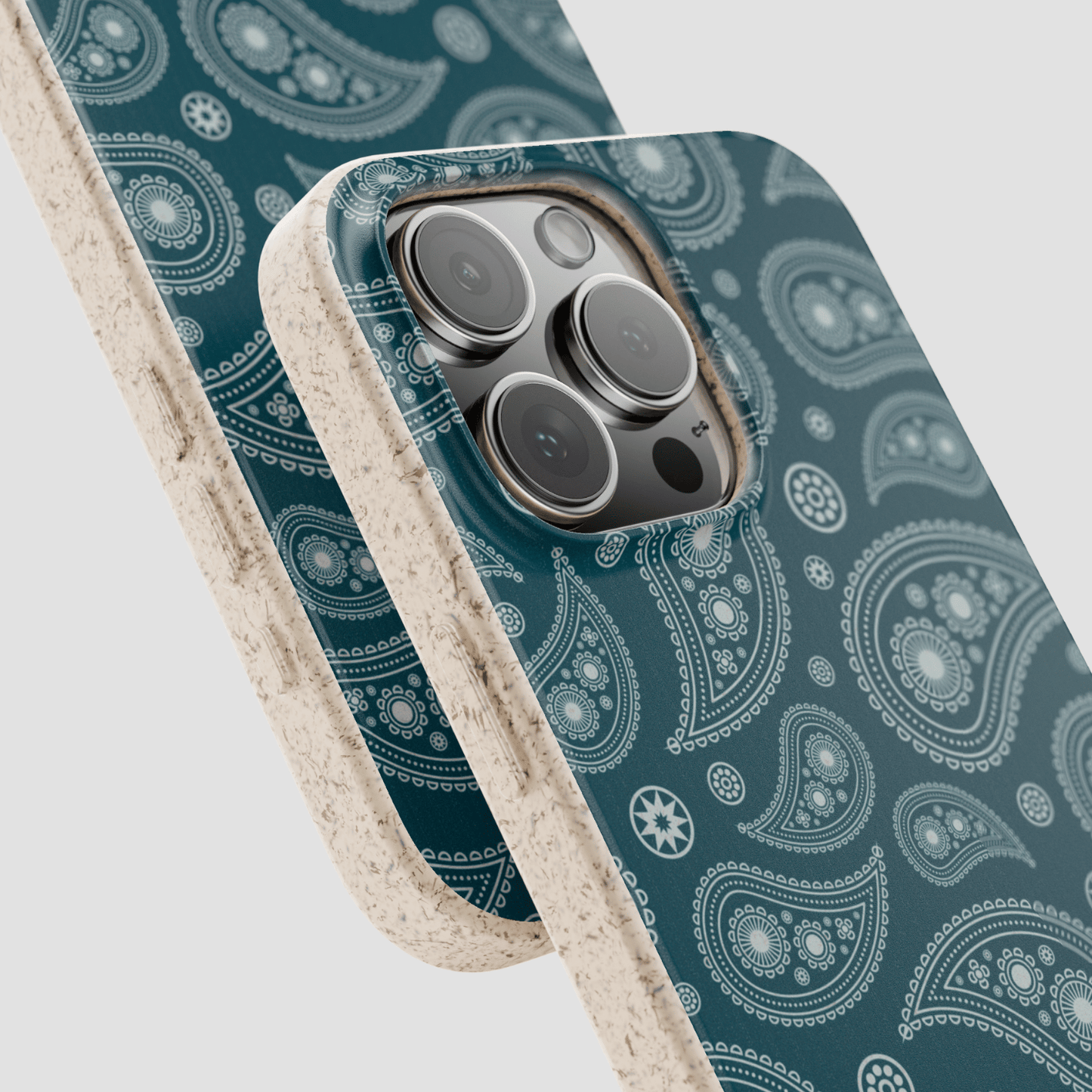 Phone case with paisley pattern and beige border on a light gray background