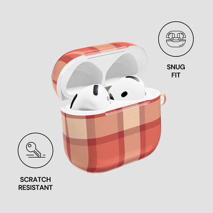 Red and beige checkered case for wireless earbuds with 'Snug Fit' and 'Scratch Resistant' features on a light gray background.
