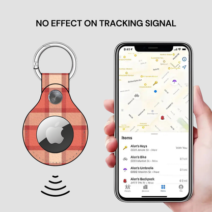 Plaid keychain tracker with Apple logo displayed on a phone app showing location tracking.