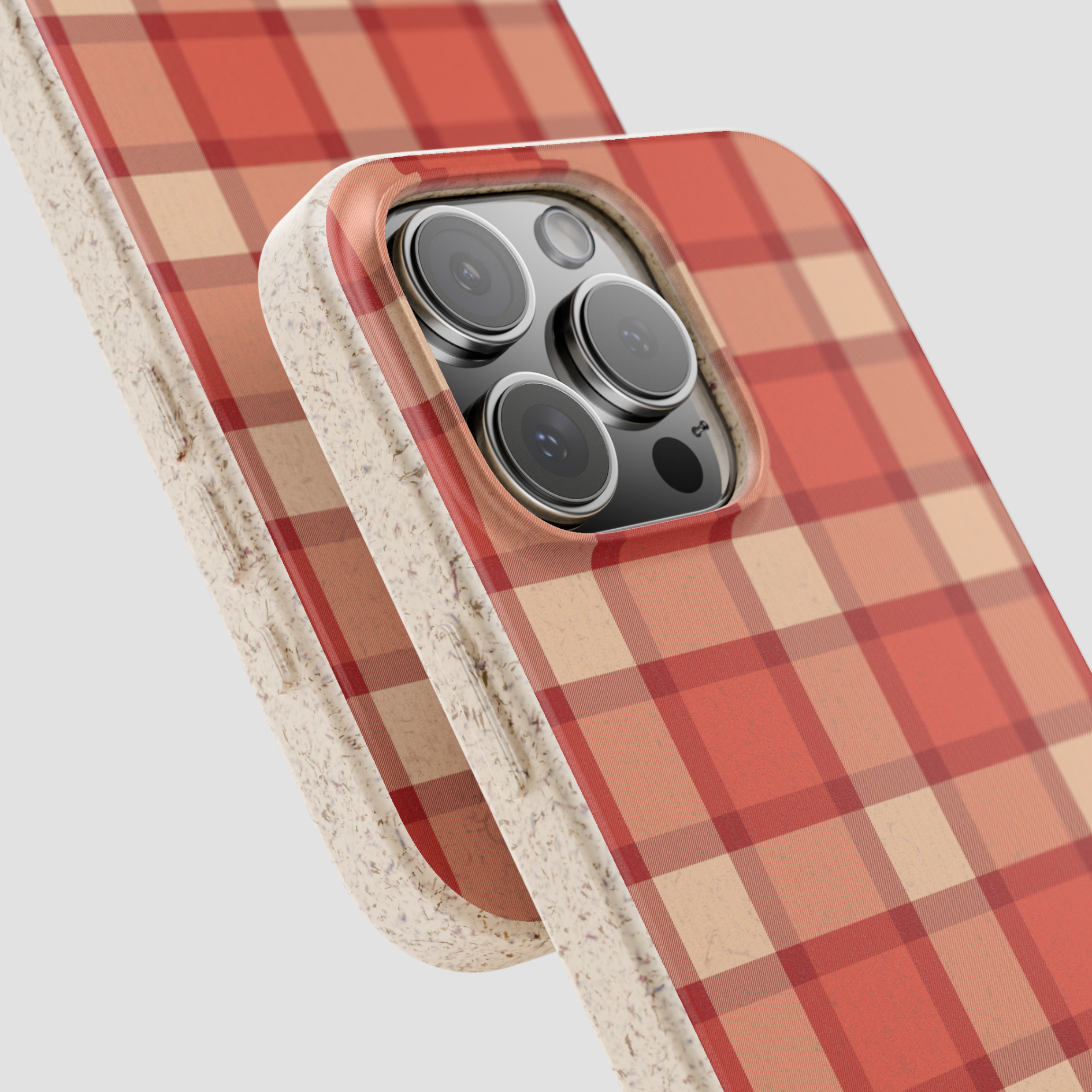 Phone case with red and beige plaid pattern on a light gray background