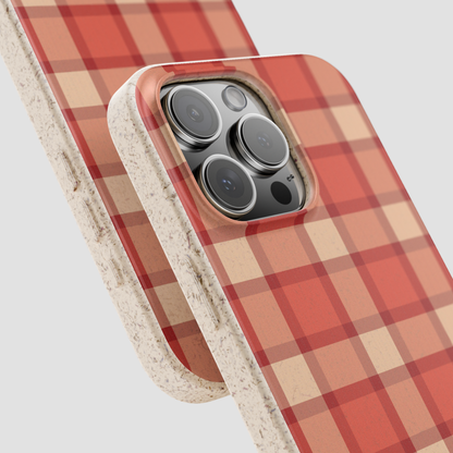 Phone case with red and beige plaid pattern on a light gray background