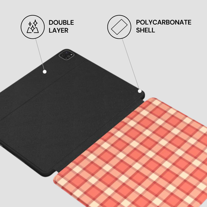 Two tablet cases, one black and one with a red and white checkered pattern, on a light gray background.