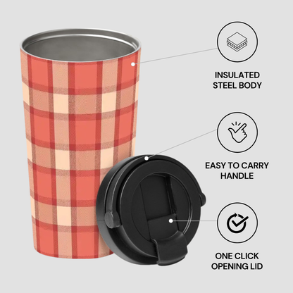 Plaid patterned tumbler with black lid on a light gray background