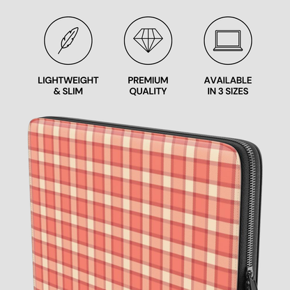 Plaid patterned laptop sleeve with icons and text on a gray background