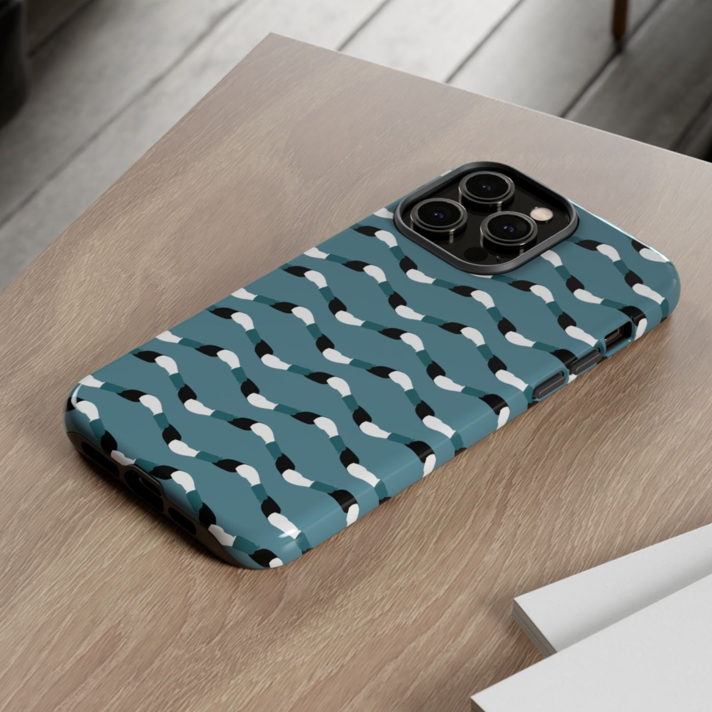 Phone case with bird pattern on a wooden surface
