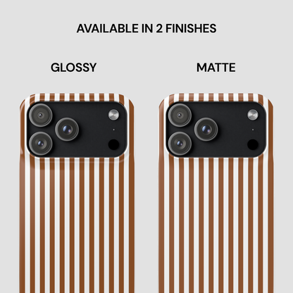 Two phone cases with glossy and matte finishes on a striped background.
