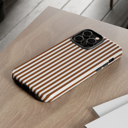 Phone case with brown and white stripes on a wooden surface