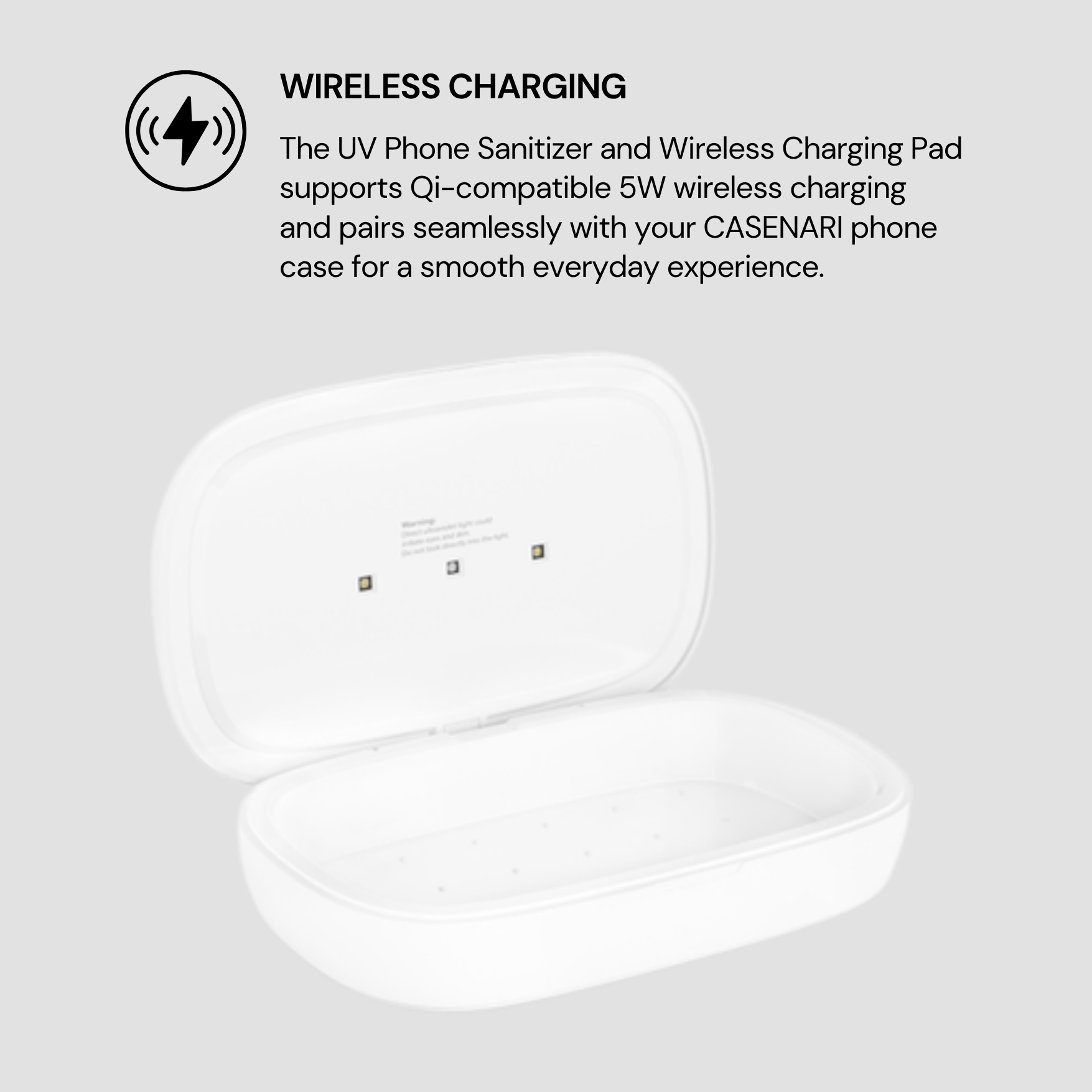 White UV phone sanitizer and wireless charging pad on a light gray background