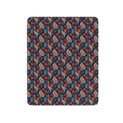 Patterned fabric swatch with red, blue, and green design on a black background