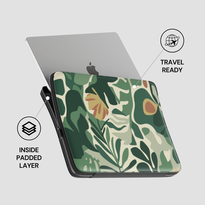 Laptop with a green leaf patterned case on a light gray background