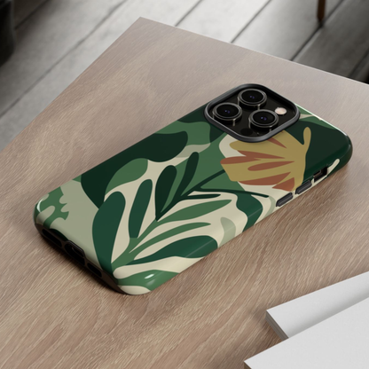 Phone case with green leaf pattern on a wooden surface