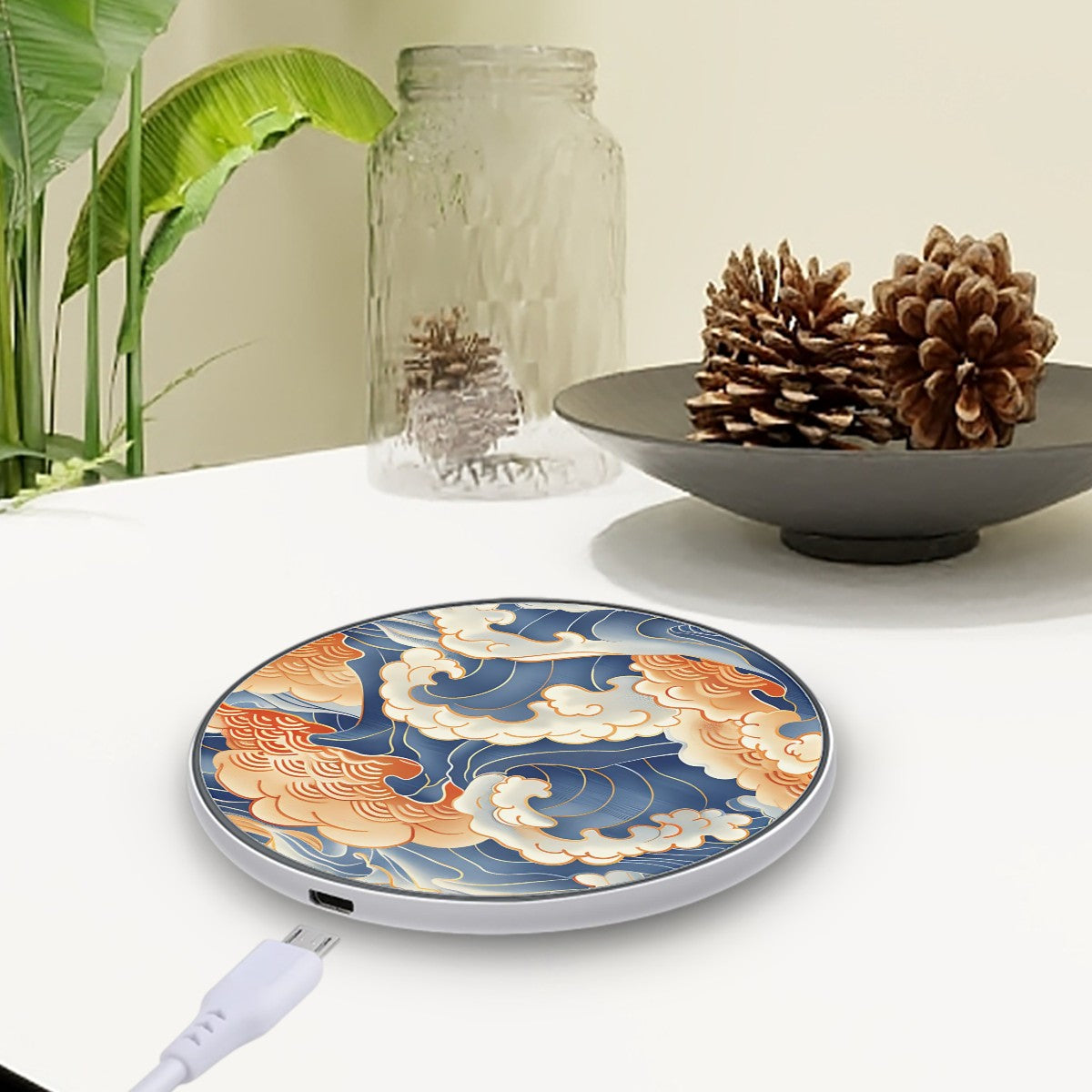 Wireless Charger with floral design on a table with a plant and decorative items.