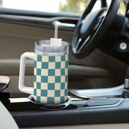 Checkered mug with a straw on a car cup holder