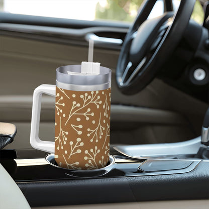 Travel mug with a brown floral pattern on a car dashboard