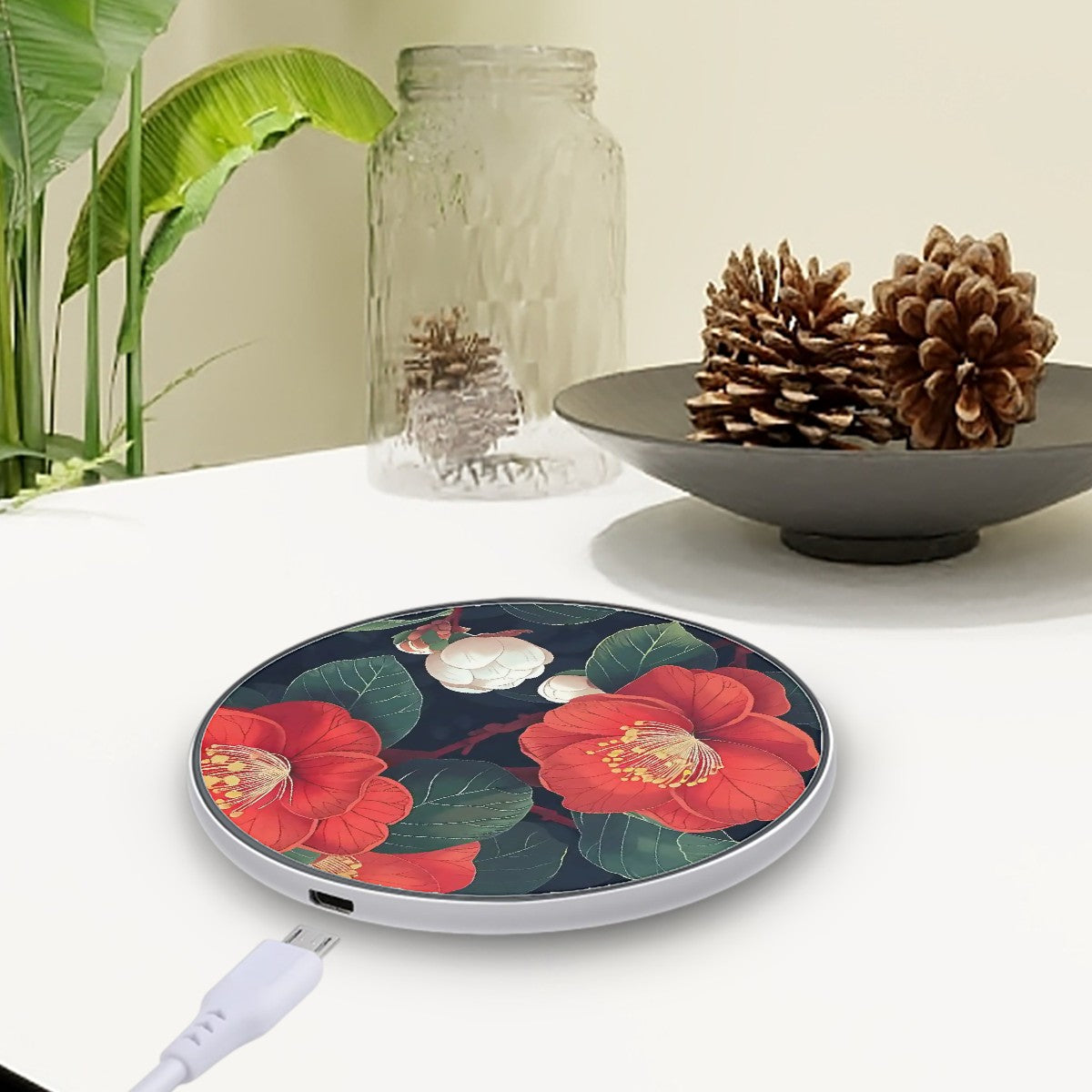 Wireless charger with floral design on a table with decorative items