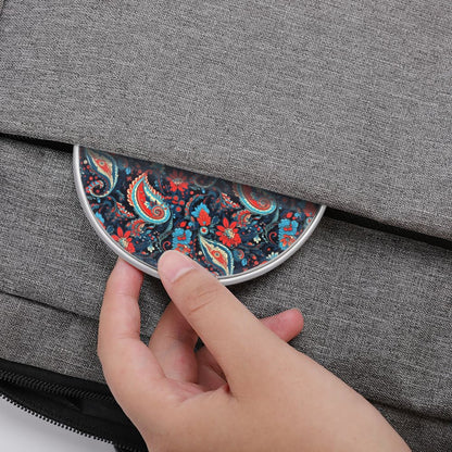 Hand opening a gray bag with a floral patterned flap