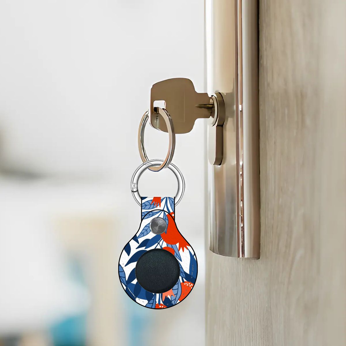 Keychain with a colorful design attached to a door handle.