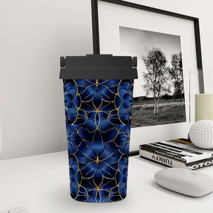 Blue patterned tumbler on a desk with a framed picture in the background