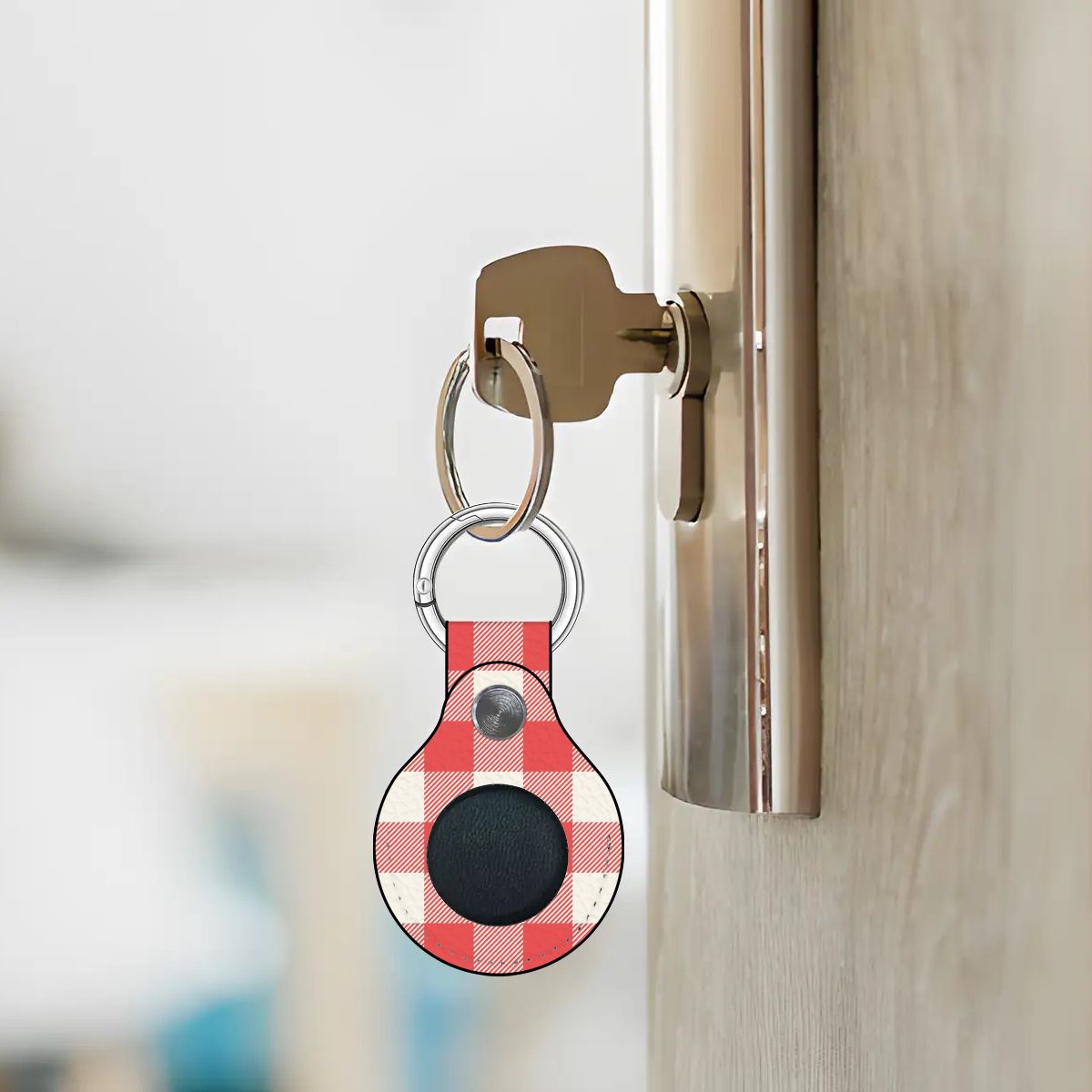 Keychain with a red and white checkered pattern attached to a door handle.