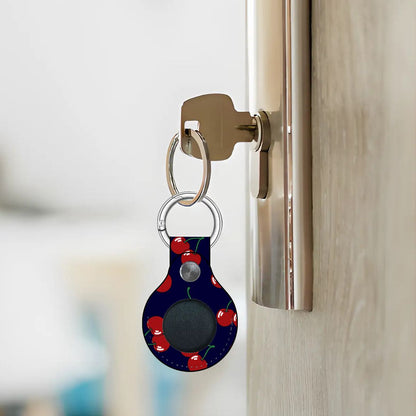 Keychain with a cherry pattern attached to a door handle.