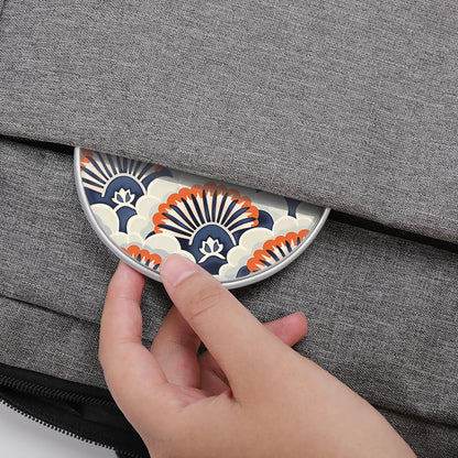 Hand placing a decorative coaster on a gray textured surface