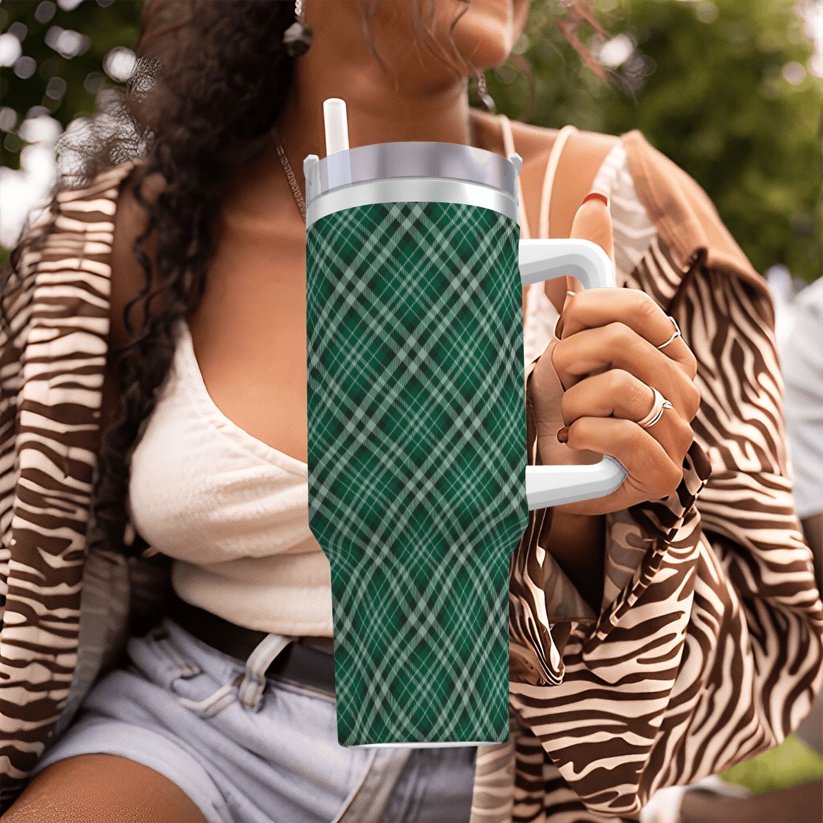 Person holding a green plaid-patterned tumbler outdoors | Casenari