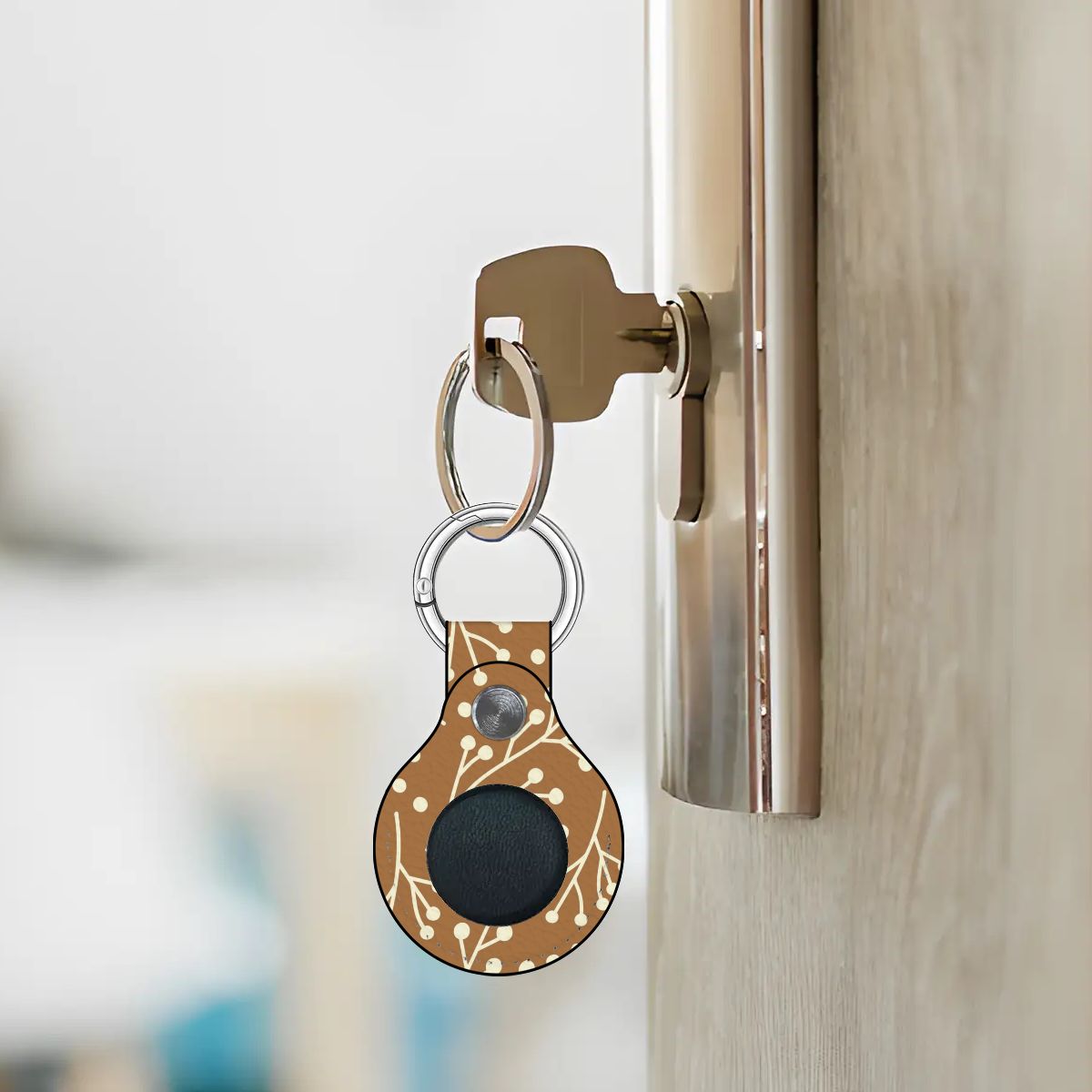 Keychain with a black circular device attached to a door handle.