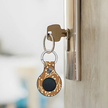 Keychain with a black circular device attached to a door handle.