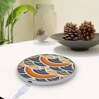 Decorative wireless charging pad with a colorful pattern on a table with a plant and decorative items.