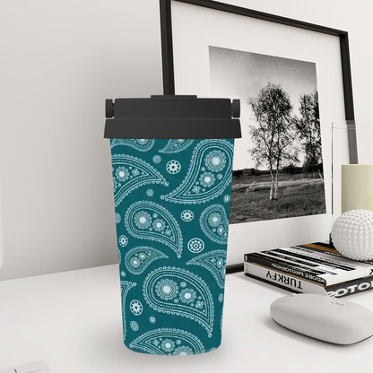 Teal patterned tumbler on a desk with a framed picture and books in the background