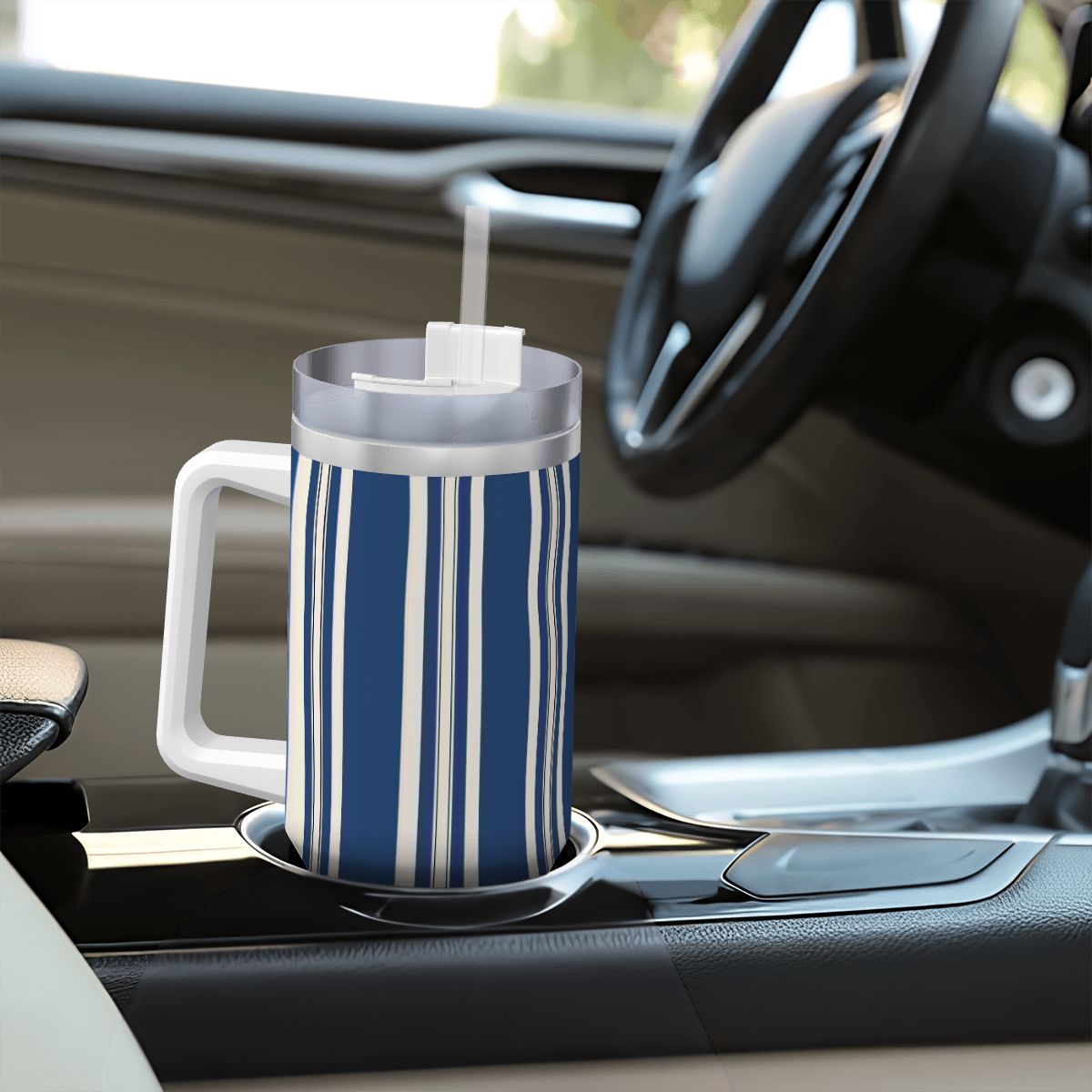 Blue and white striped mug with a straw on a car cup holder