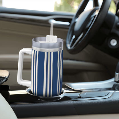 Blue and white striped mug with a straw on a car cup holder