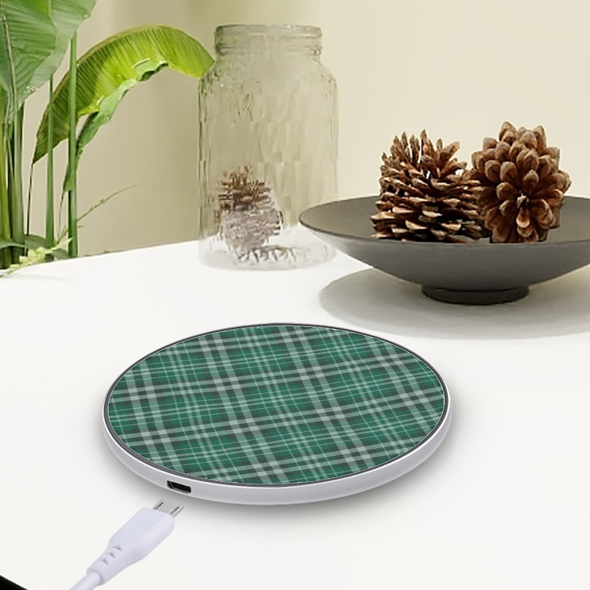 Green plaid wireless charging pad on a white surface with decorative elements. | Casenari