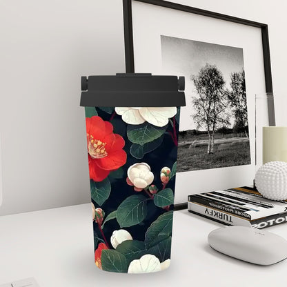 Tumbler with floral design on a desk next to a framed black and white photo