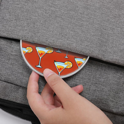 Coaster with cocktail design being placed into a gray bag