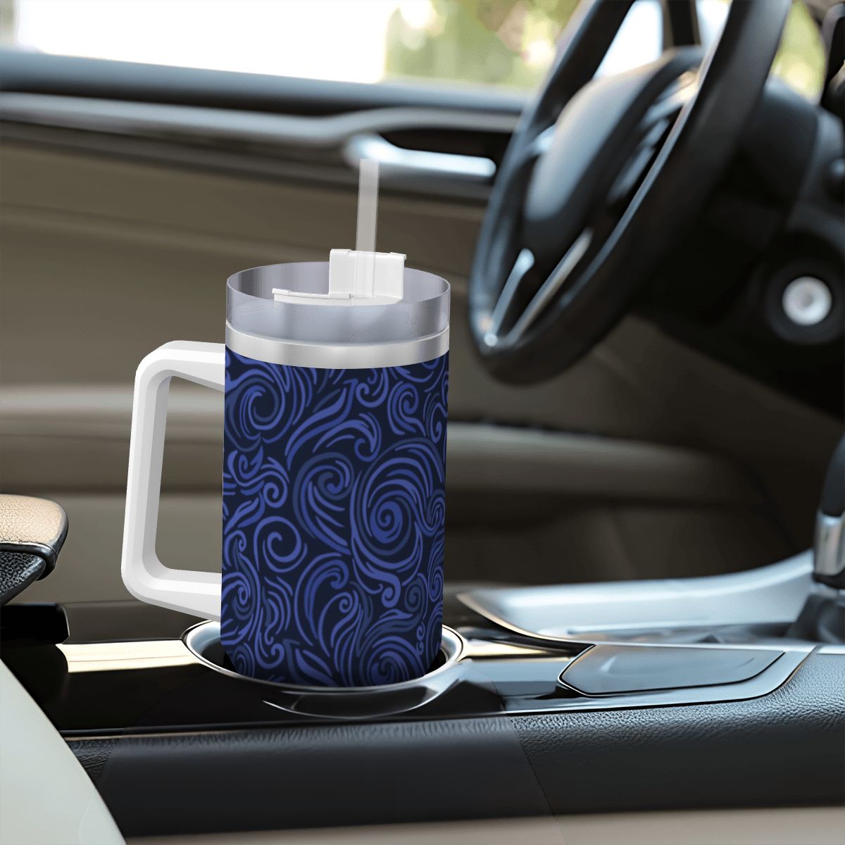 Blue patterned mug with a straw on a car dashboard