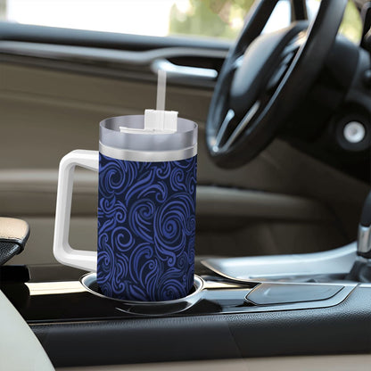 Blue patterned mug with a straw on a car dashboard