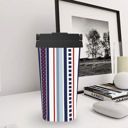 Tumbler with striped design on a desk next to a framed picture and books