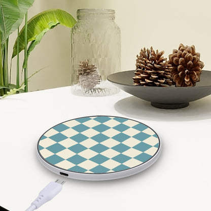 Wireless charging pad with blue and white checkered design on a table with decorative items.