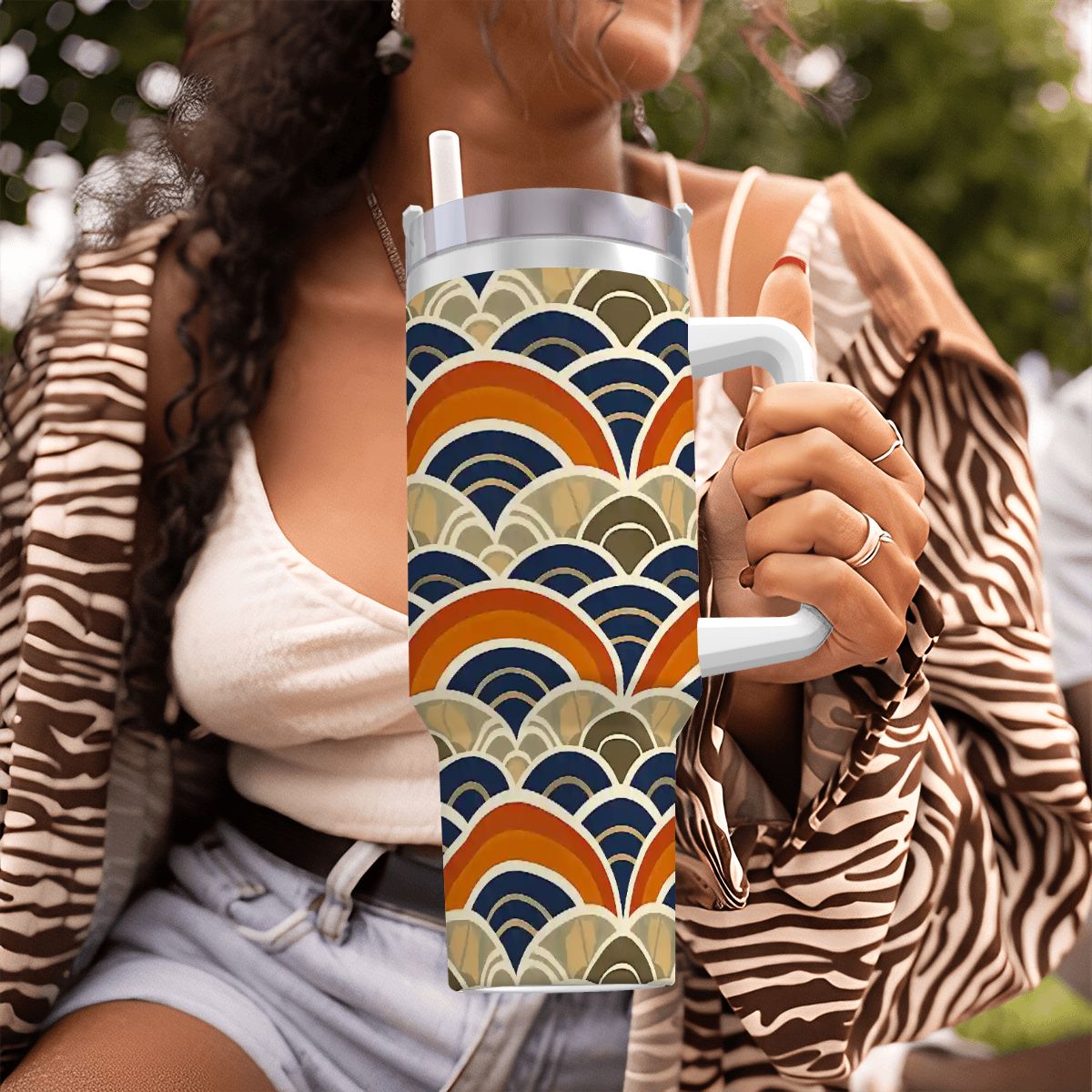 Person holding a mug with a colorful wave pattern