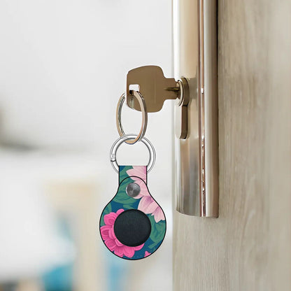 Keychain with a floral design attached to a door handle.